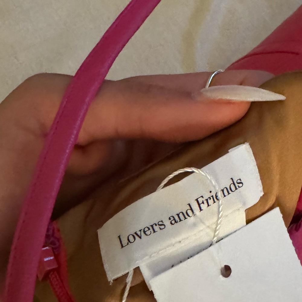 Pink leather mini dress. Cross in front. Lovers and friends size small